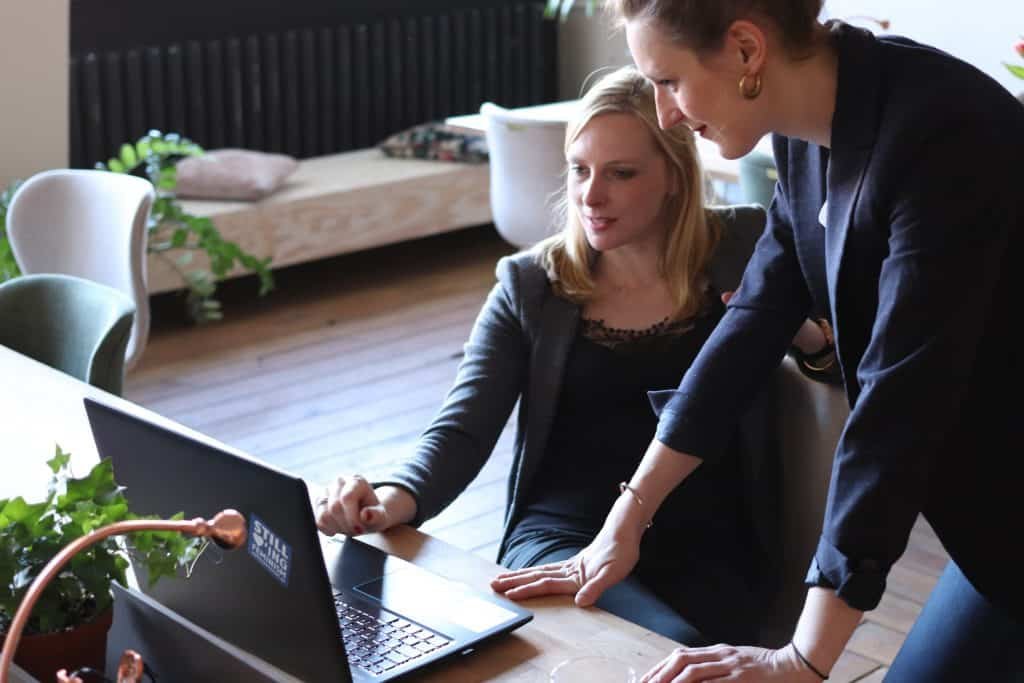 Two women looking at the laptop